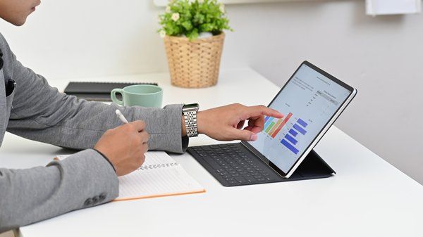 A person is working on the laptop and measuring analytics