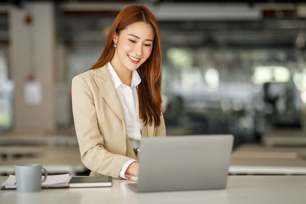 A woman working on laptop in office