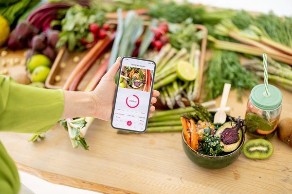 A woman holding her phone with showcasing nutritional analysis 