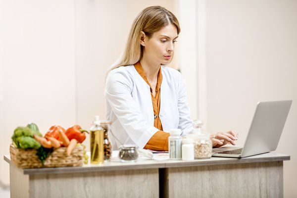 A health professional working on her laptop